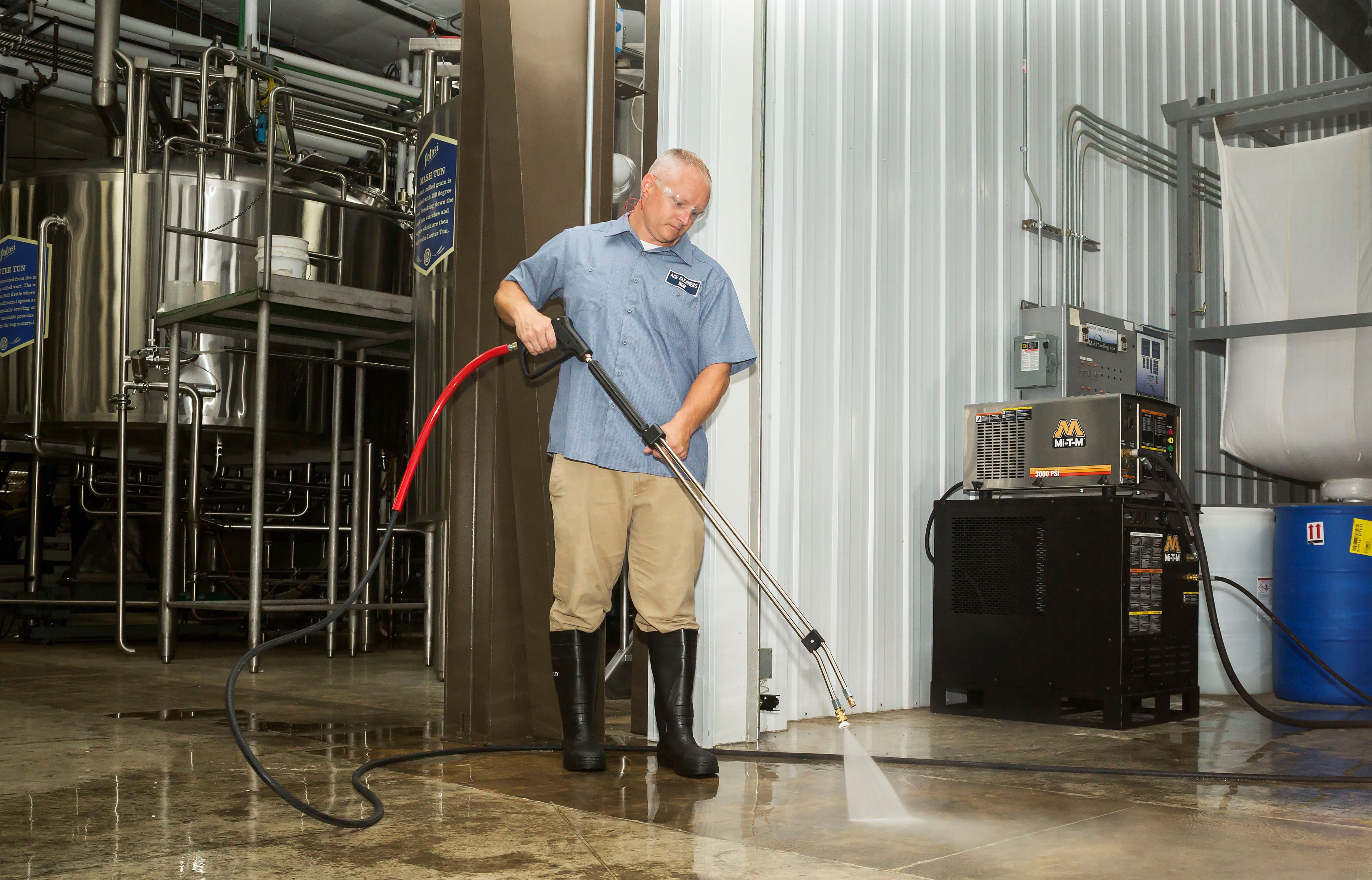 Man standing next to Mi-T-M Equipment