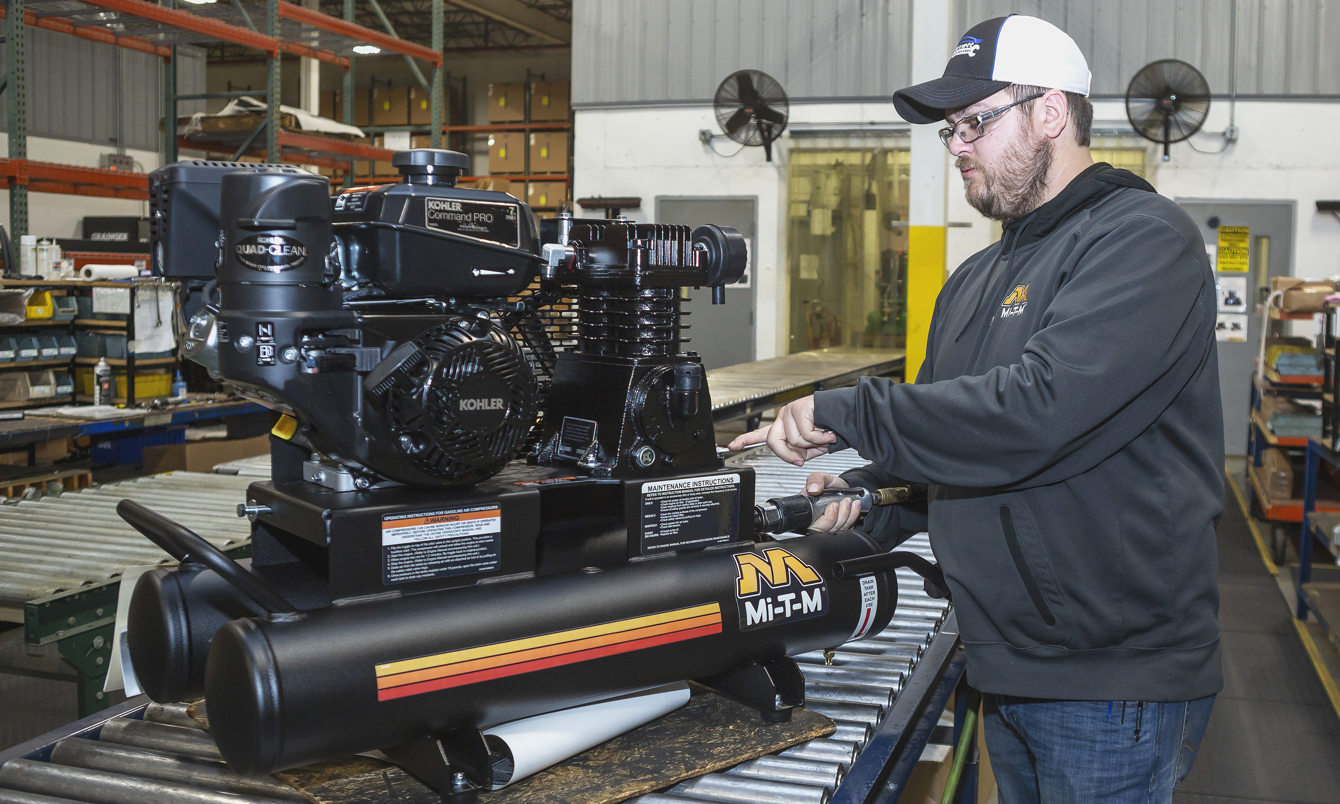 Man standing next to Mi-T-M Equipment